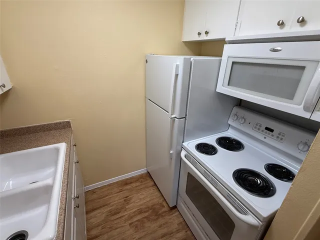 a kitchen with a stove and a microwave