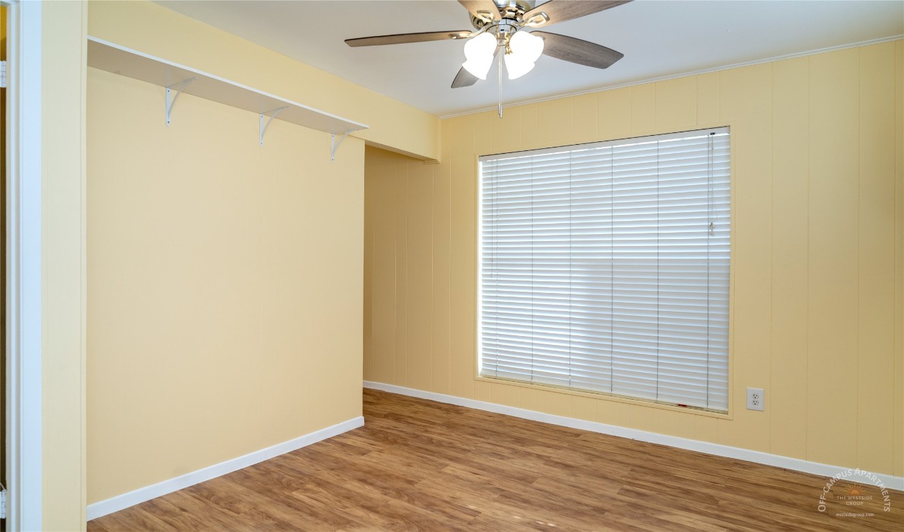 2108 San Gabriel Street, Unit 201 Austin, TX 78705 - Photo 10 of 15 a view of an empty room with wooden floor and a window