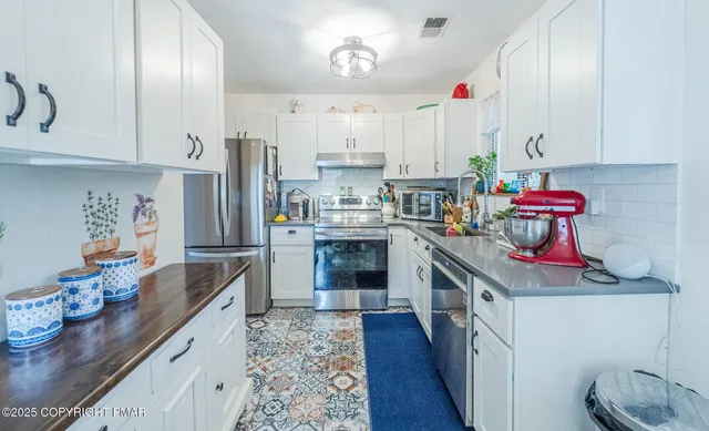 a kitchen with kitchen island granite countertop lots of counter top space