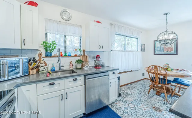 a kitchen with a dining table cabinets and a window