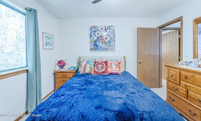 a view of hallway with wooden floor and cabinet