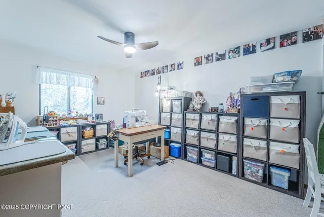 a room with furniture a air conditioner vent and a window