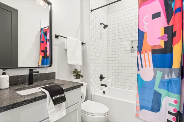a bathroom with a double vanity sink mirror and shower