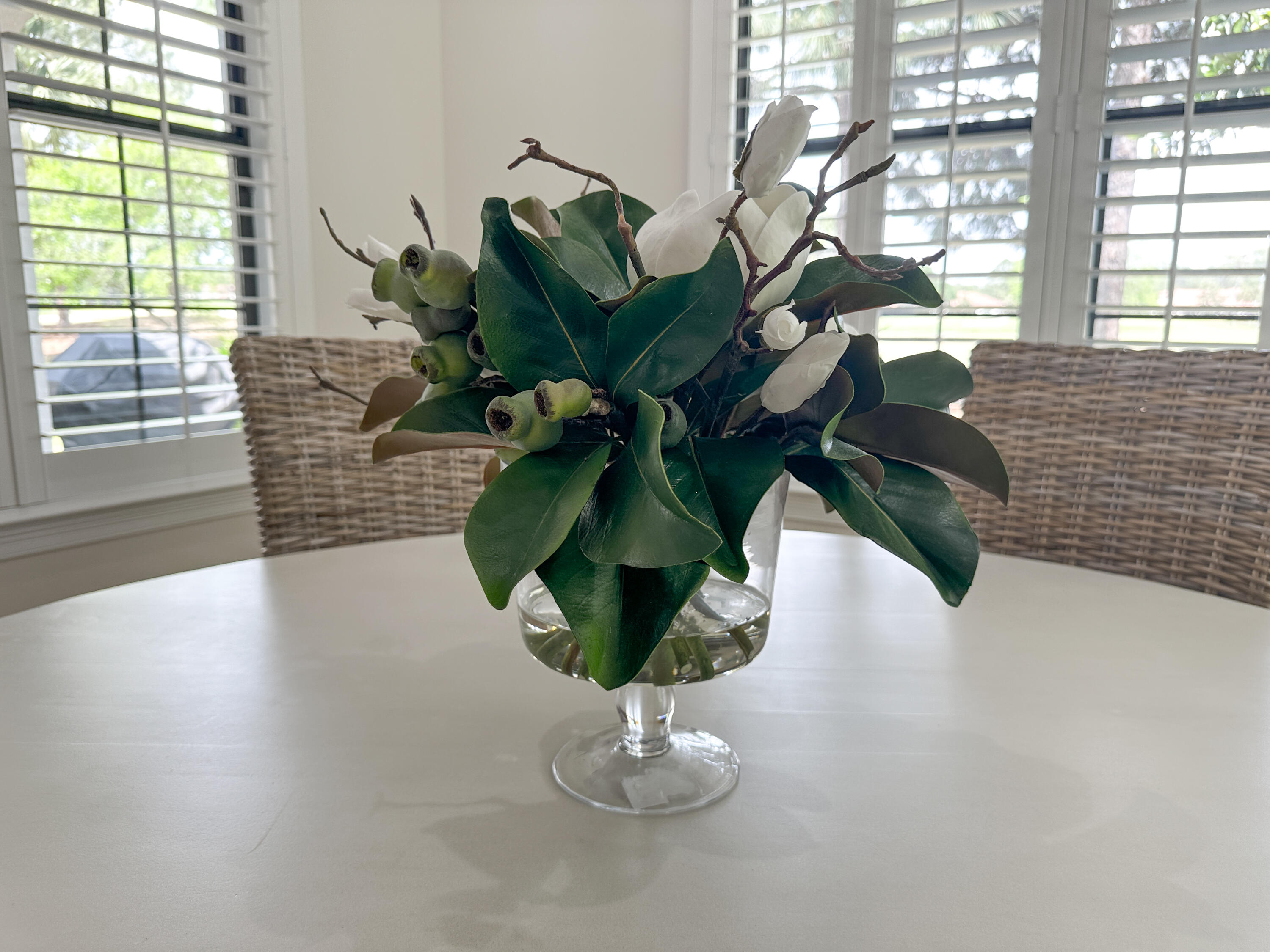 1893 Baytowne Loop Miramar Beach, FL 32550 - Photo 24 of 58 a vase of flowers sitting on a table with window
