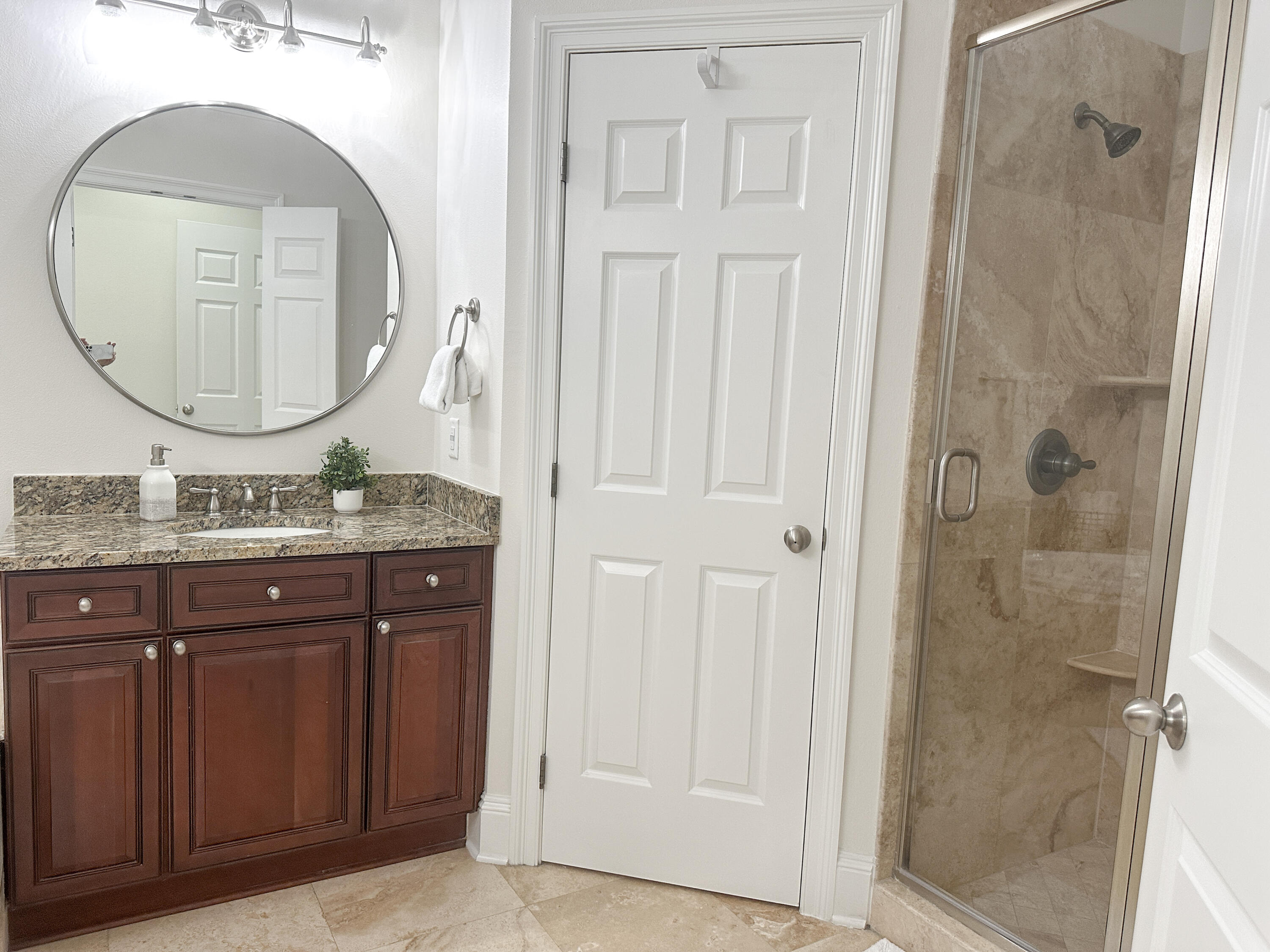1893 Baytowne Loop Miramar Beach, FL 32550 - Photo 37 of 58 a bathroom with a granite countertop sink a mirror and a shower
