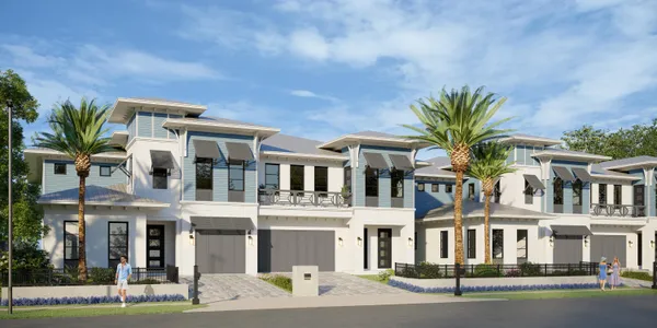 a front view of a residential apartment building with a yard and balcony