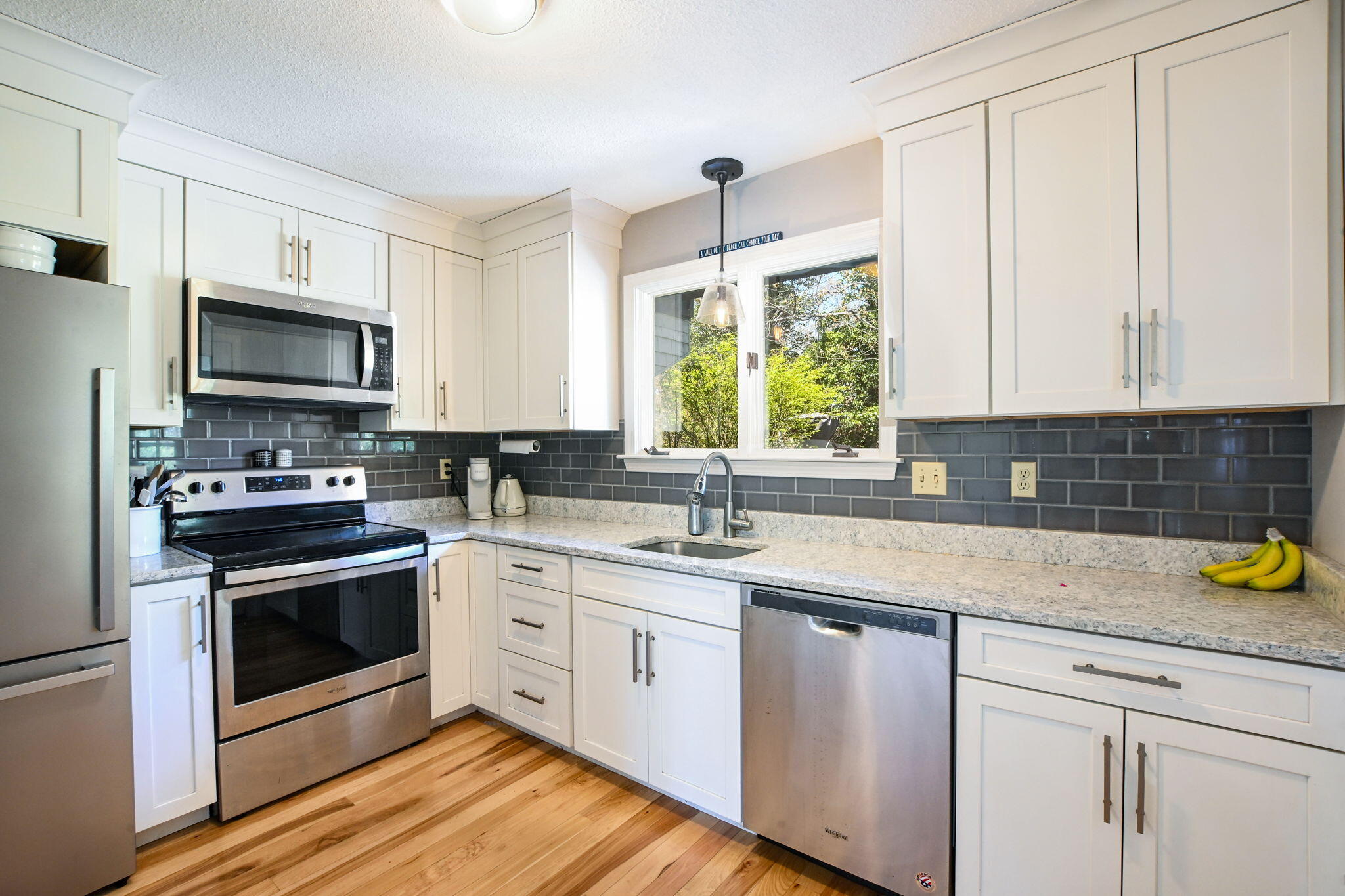 59 Main Street, Unit 20-3 Dennis, MA 02638 - Photo 11 of 40 a kitchen with a sink stove and microwave