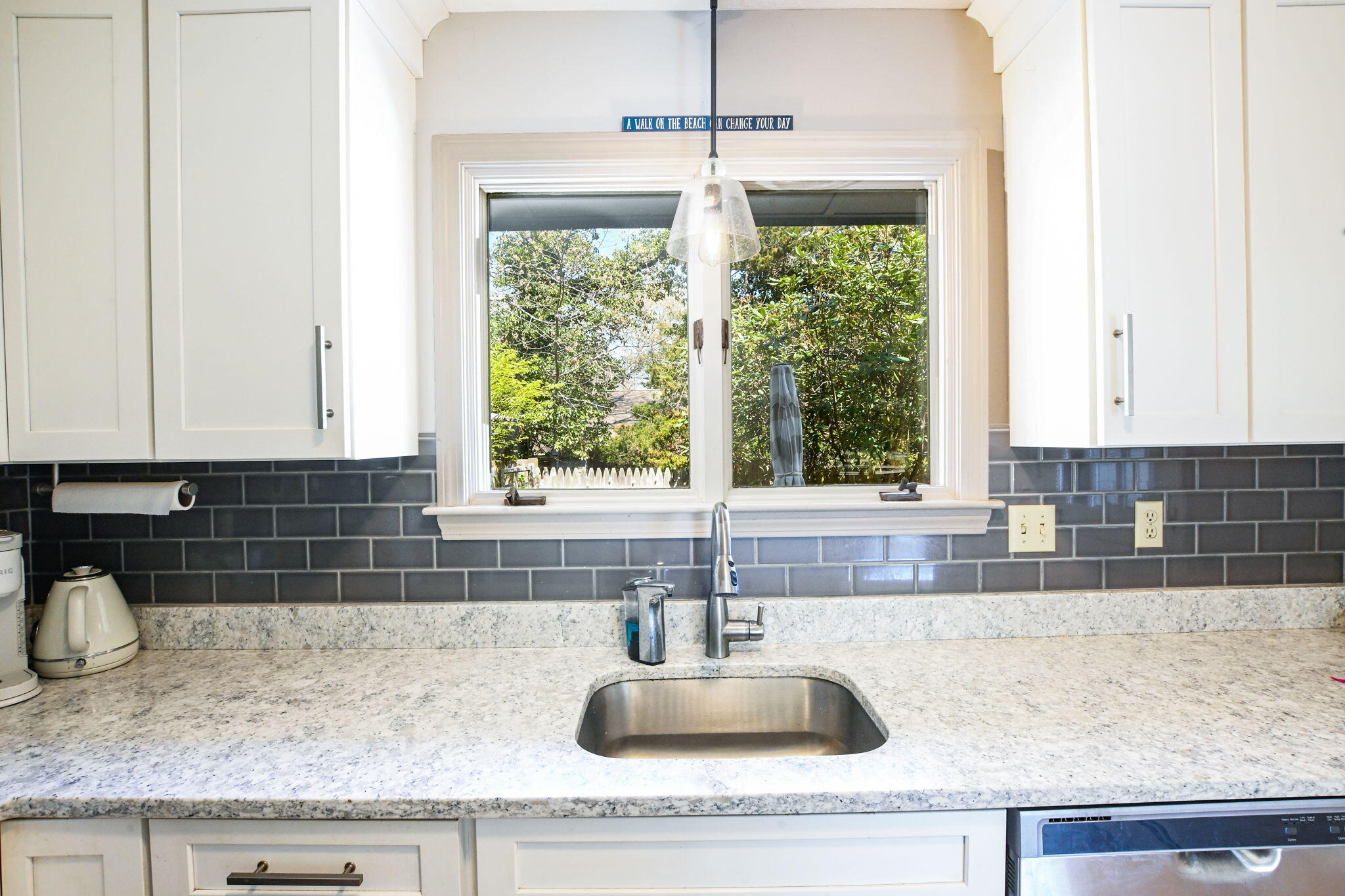 59 Main Street, Unit 20-3 Dennis, MA 02638 - Photo 12 of 40 a kitchen with granite countertop a sink and a window