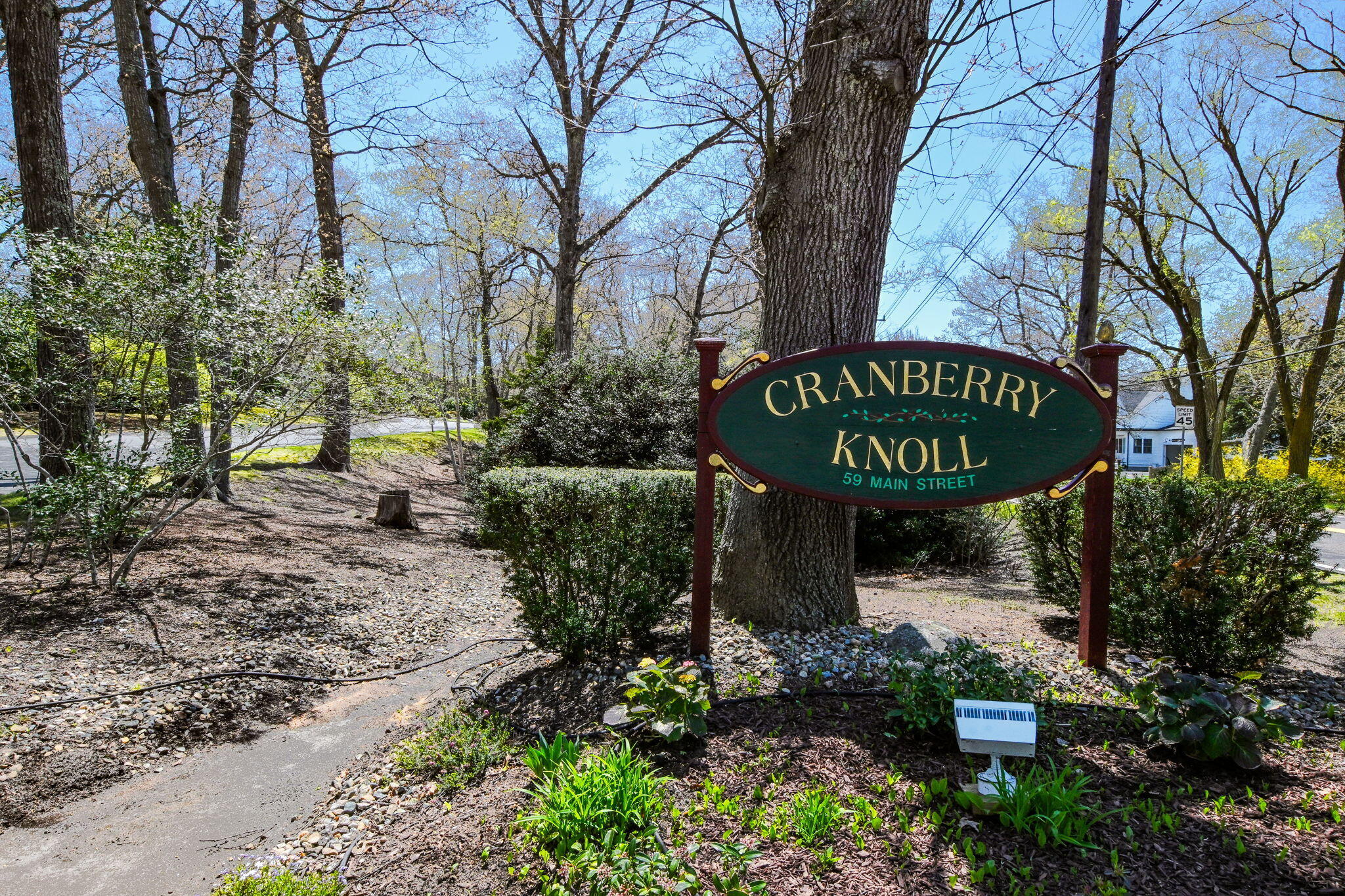 59 Main Street, Unit 20-3 Dennis, MA 02638 - Photo 30 of 40 a view of a sign under a tree