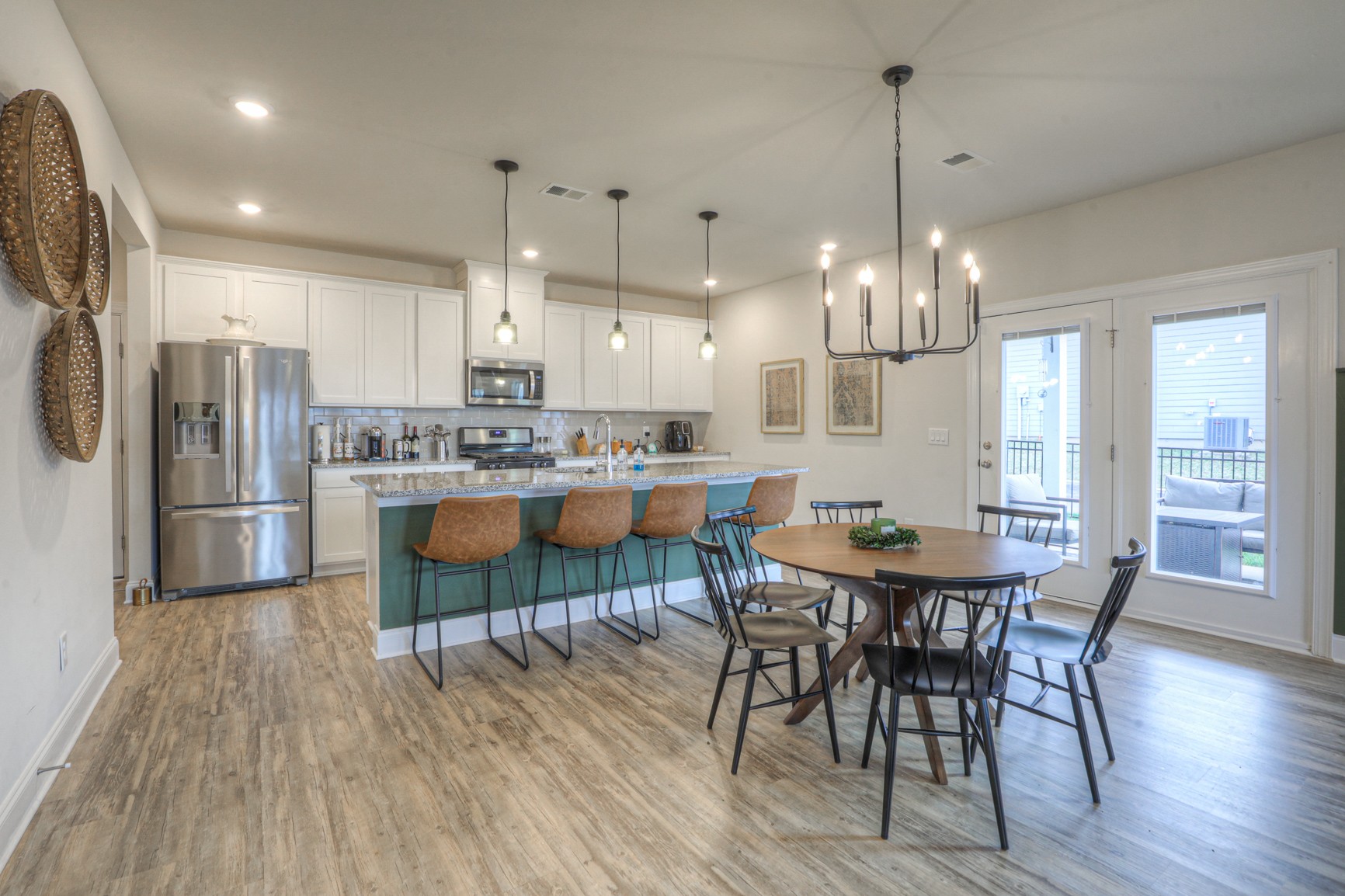 2072 Notchleaf Road Antioch, TN 37013 - Photo 5 of 30 a kitchen with stainless steel appliances kitchen island granite countertop a dining table chairs and white cabinets