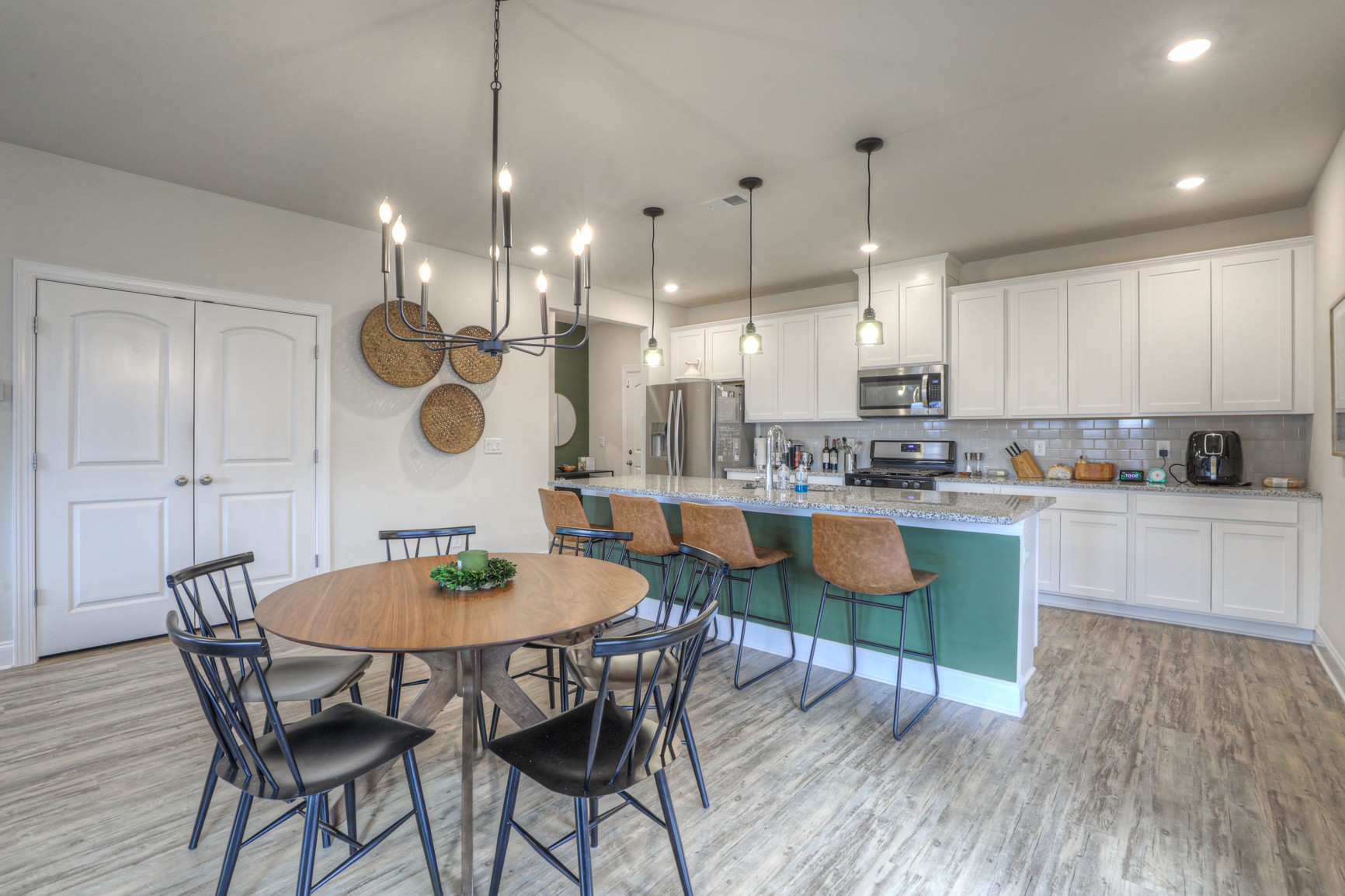 2072 Notchleaf Road Antioch, TN 37013 - Photo 6 of 30 a kitchen with stainless steel appliances kitchen island granite countertop a kitchen island a stove a table and chairs