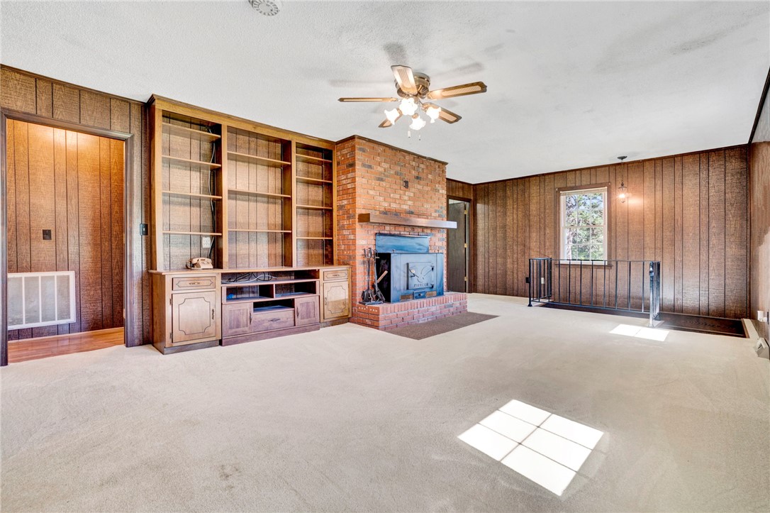 7876 Highway 11 Walhalla, SC 29691 - Photo 29 of 35 A classic fireplace with a brick hearth anchors this inviting living space, complemented by built-in shelving.