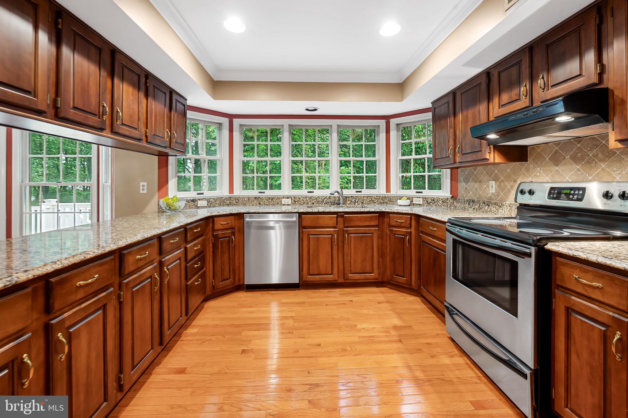 6902 Raven Lane Columbia, MD 21044 - Photo 14 of 47 a kitchen with stainless steel appliances granite countertop a sink and a stove
