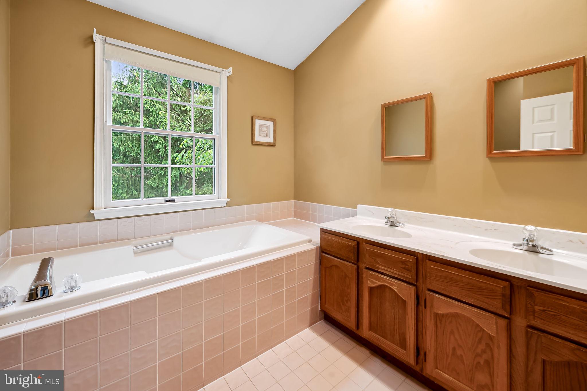 6902 Raven Lane Columbia, MD 21044 - Photo 28 of 47 a spacious bathroom with a tub sink and mirror