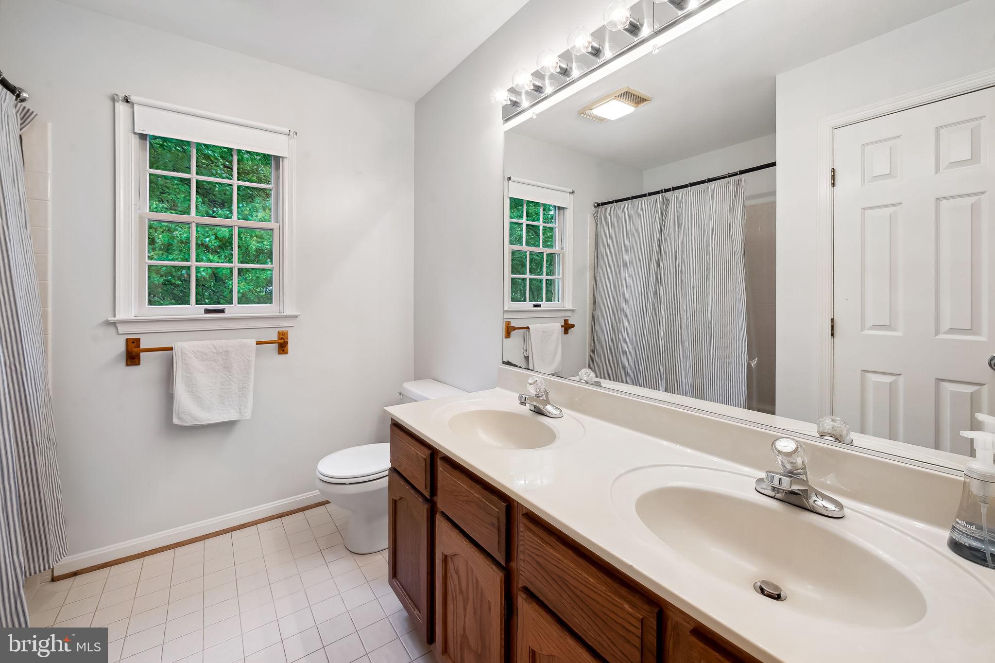 6902 Raven Lane Columbia, MD 21044 - Photo 32 of 47 a bathroom with a sink double vanity and a mirror