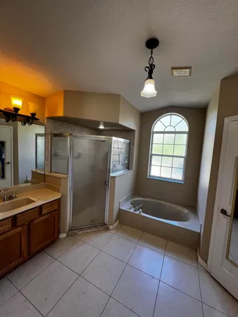 a bathroom with a tub and shower
