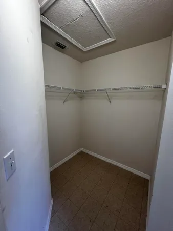 a bed room with a bed and a chair