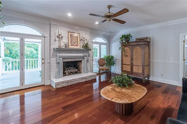a living room with furniture a fireplace and wooden floor
