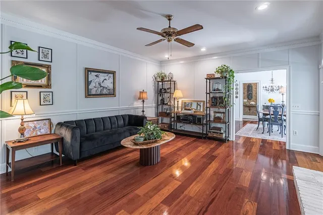 a living room with furniture and a wooden floor