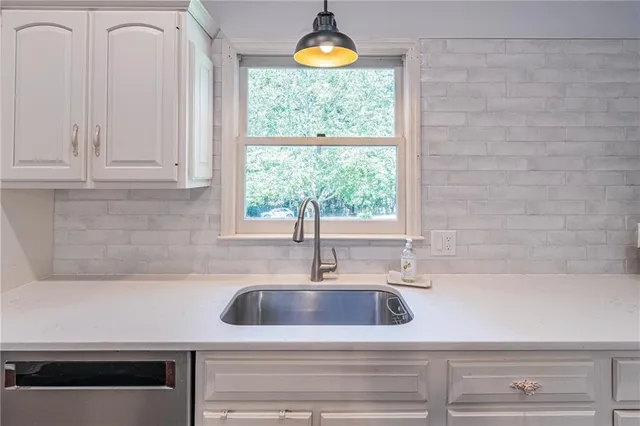 a bathroom with a double vanity sink and mirror with shower