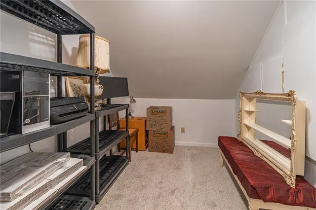 a spacious bedroom with a bed and a chandelier