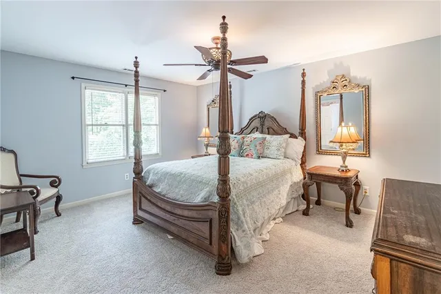 a view of a livingroom with a ceiling fan and window