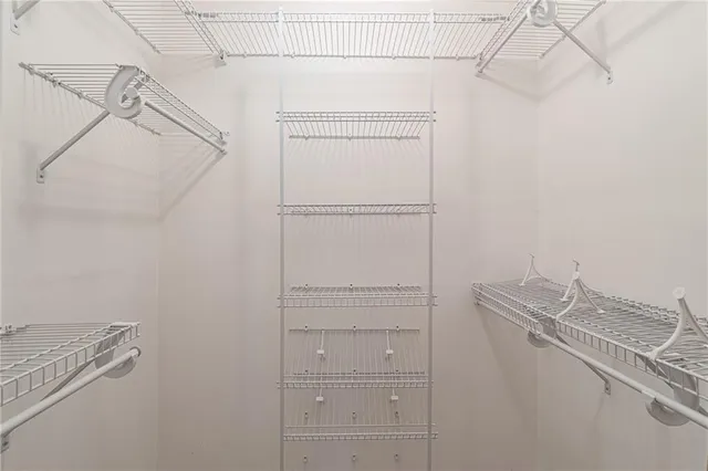 a view of a house with a small yard and large tree