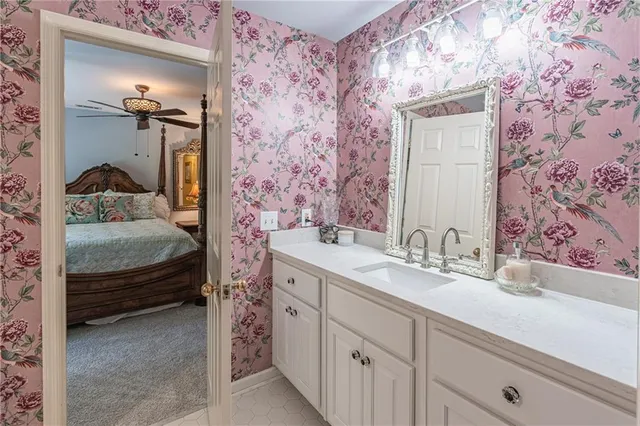 a view of a patio with a table chairs and a floor to ceiling window
