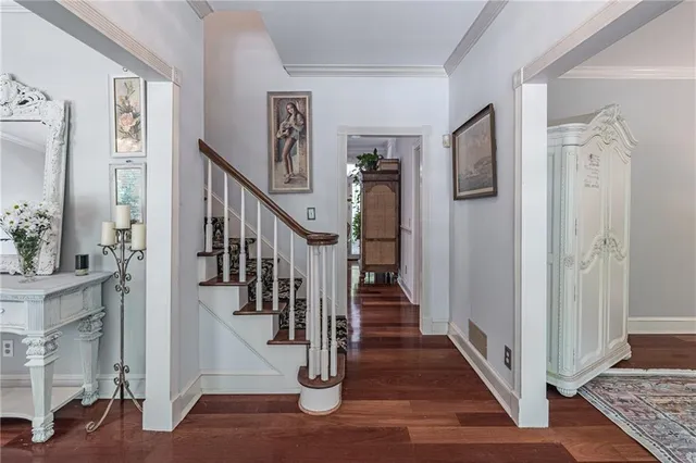a view of a hallway with wooden floor and entryway