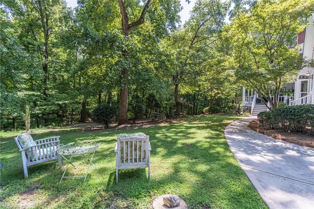 a aerial view of a house with a yard and large tree