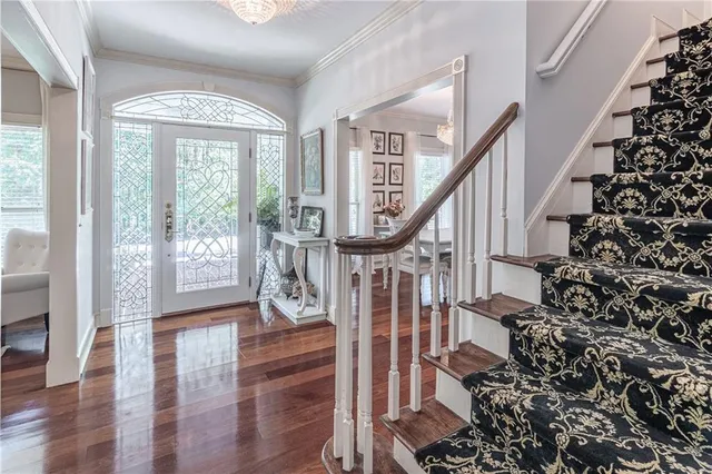 a view of entryway with wooden floor and windows