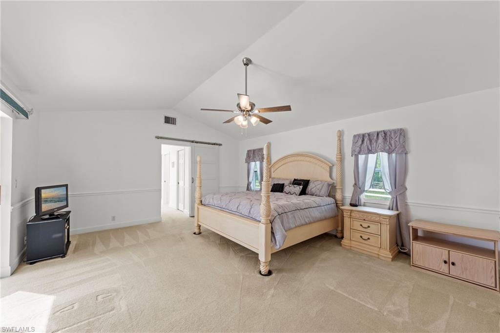 13541 Stringfellow Road Bokeelia, FL 33922 - Photo 14 of 49 a bedroom with a white bed and dresser