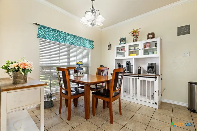 a view of a dining room with furniture and chandelier