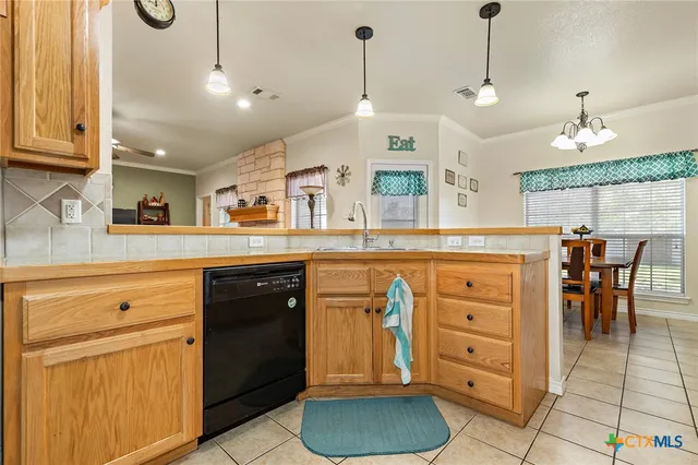 a kitchen with a cabinets and chandelier