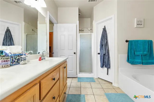 a bathroom with a tub sink and a mirror