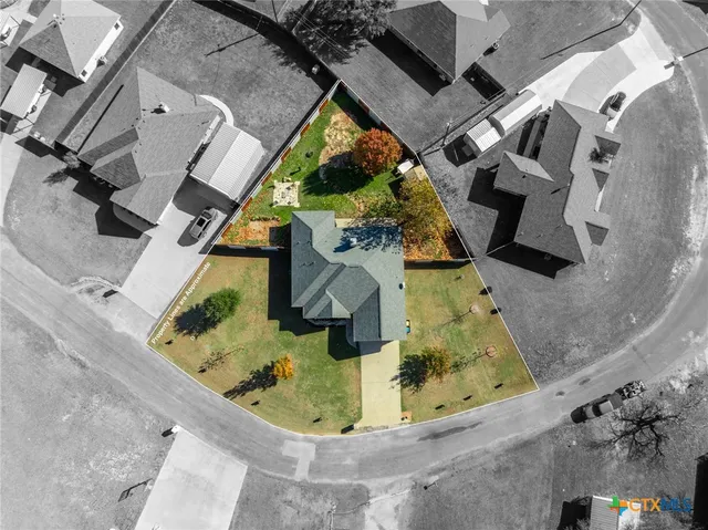 an aerial view of a house with a swimming pool