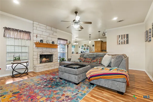 a living room with furniture a flat screen tv and a fireplace
