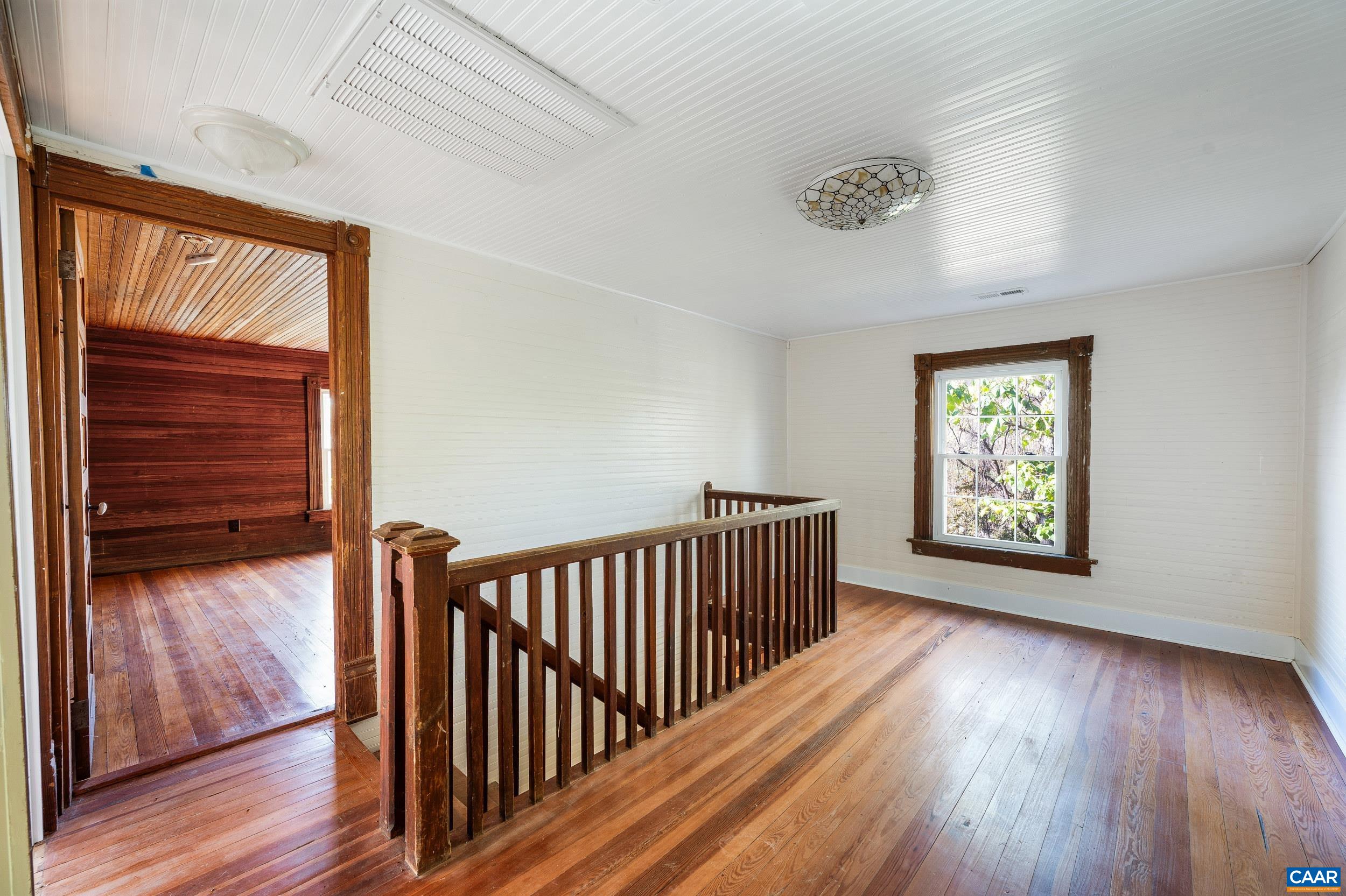 2728 East Branch Loop Roseland, VA 22967 - Photo 16 of 45 a view of a hallway with wooden floor and a window
