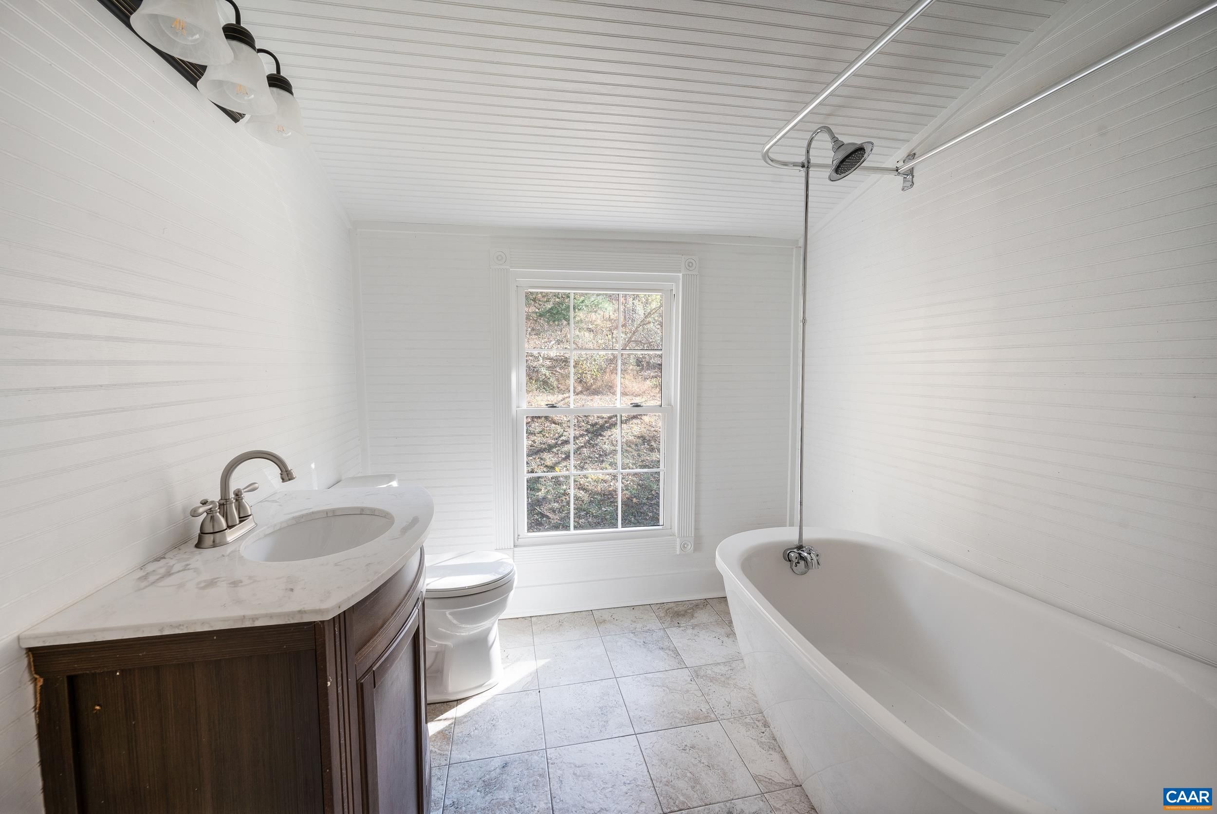 2728 East Branch Loop Roseland, VA 22967 - Photo 21 of 45 a bathroom with a granite countertop sink a toilet and bathtub