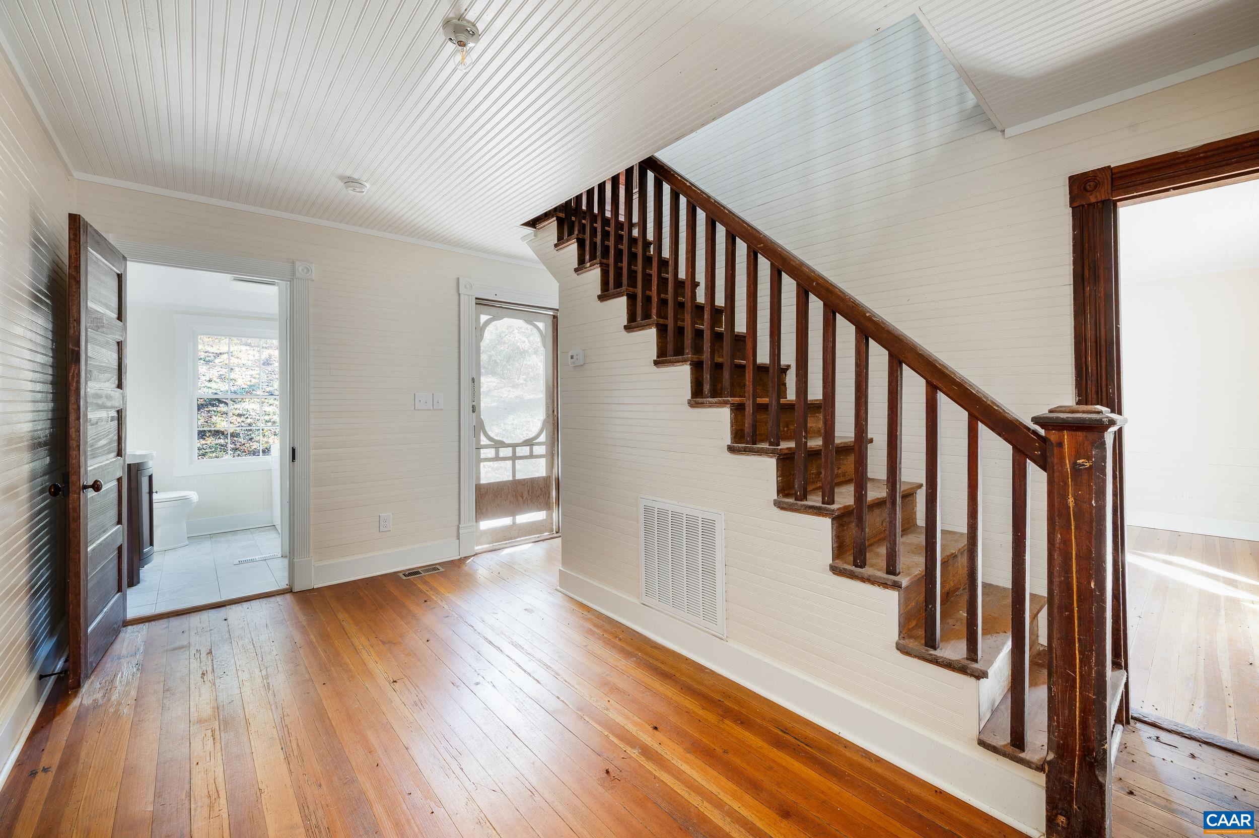 2728 East Branch Loop Roseland, VA 22967 - Photo 4 of 45 a view of staircase with wooden floor and a chandelier