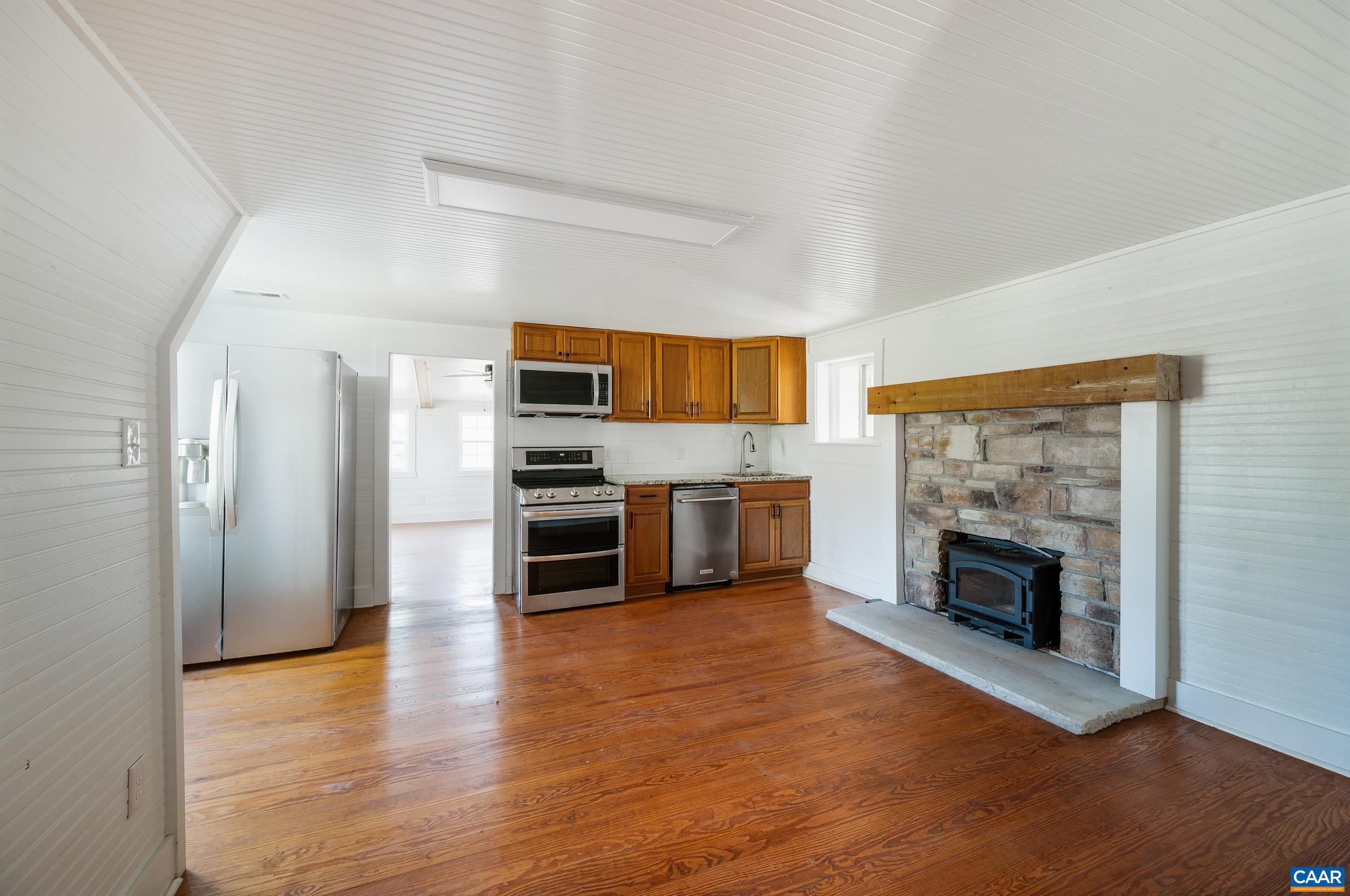 2728 East Branch Loop Roseland, VA 22967 - Photo 8 of 45 a kitchen with stainless steel appliances a stove top oven a refrigerator and a fireplace