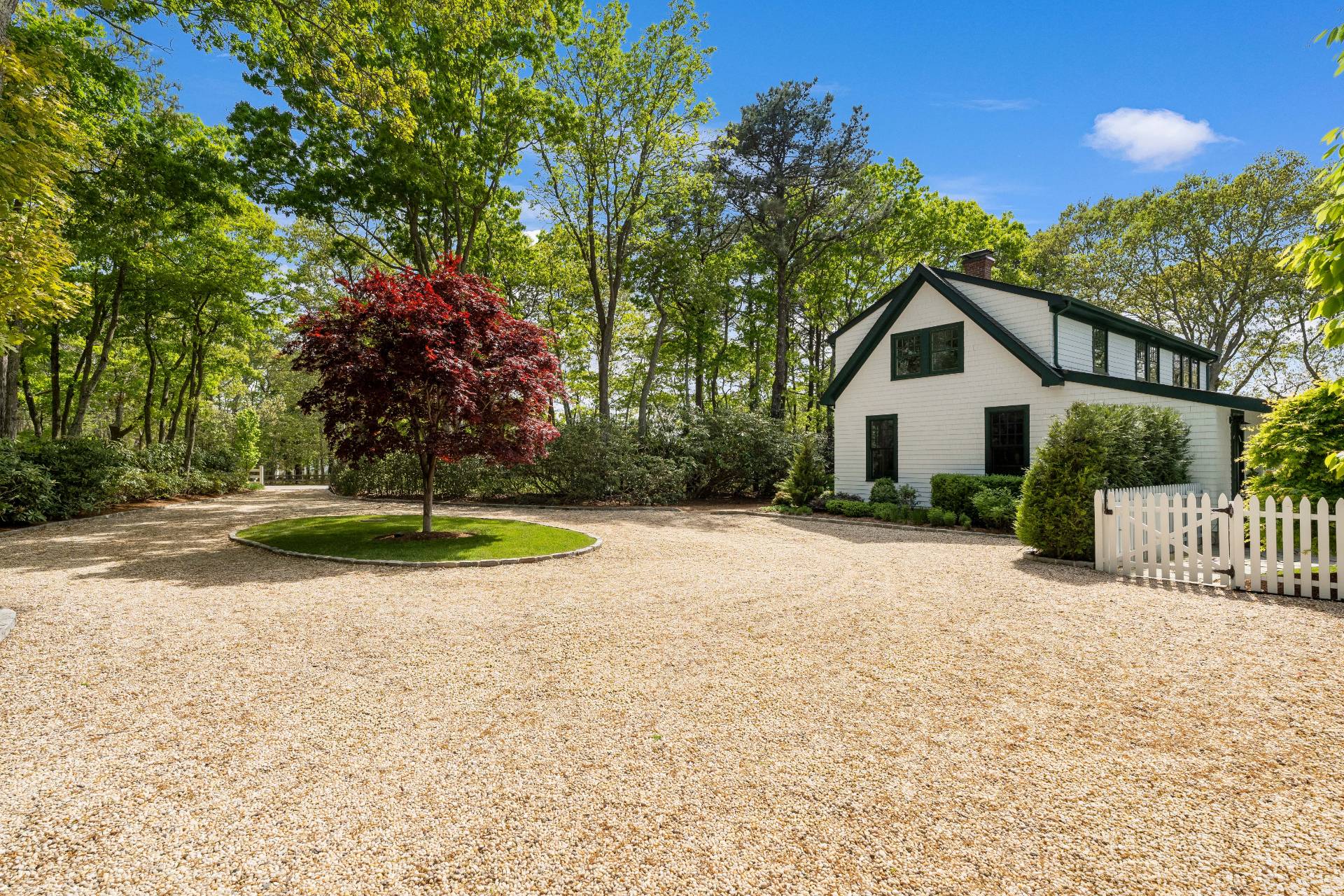 91 East Tiana Road Hampton Bays, NY 11946 - Photo 44 of 46 a view of a house with a small yard and large trees