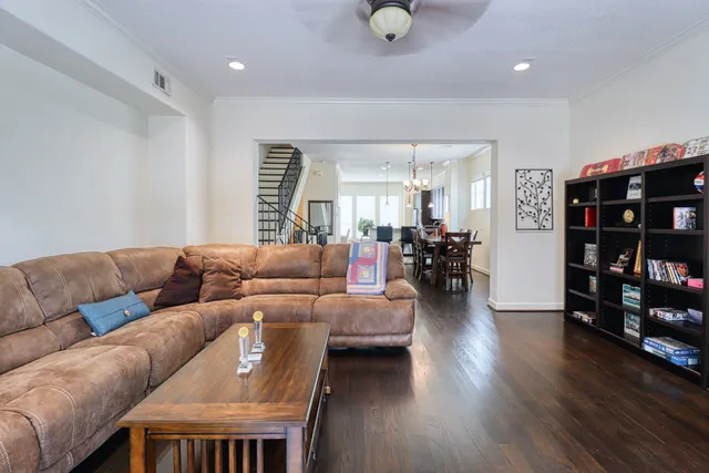 a living room with furniture and wooden floor