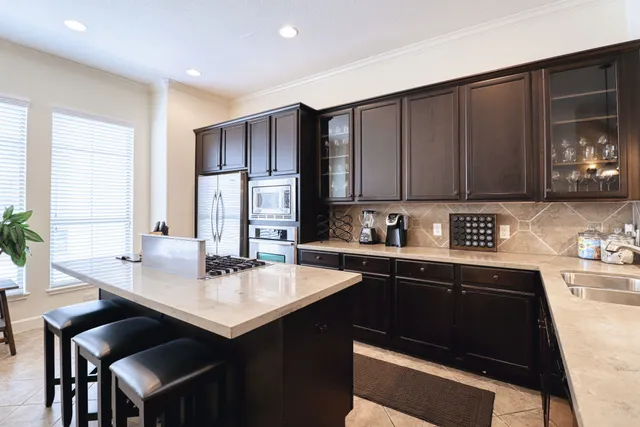 a kitchen with a sink cabinets and window