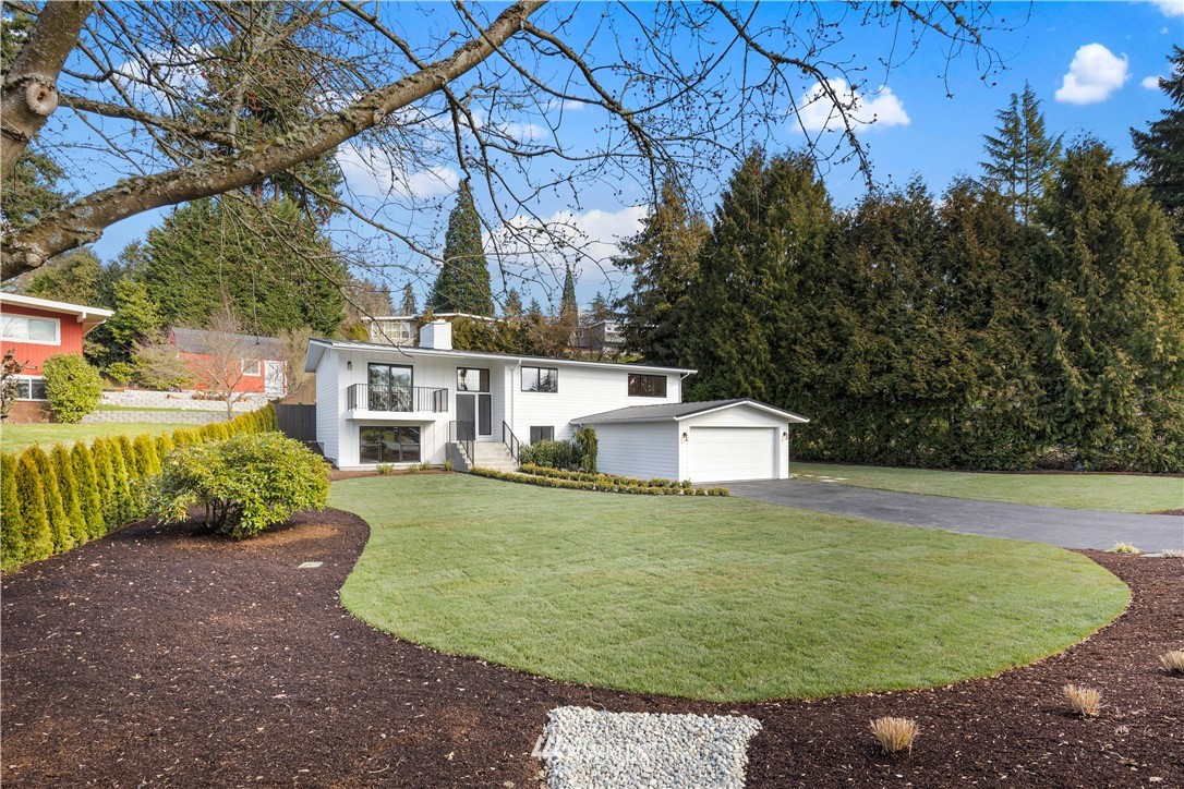 12106 Southeast 26th Street Bellevue, WA 98005 - Photo 2 of 32 a view of a white house with a yard and potted plants