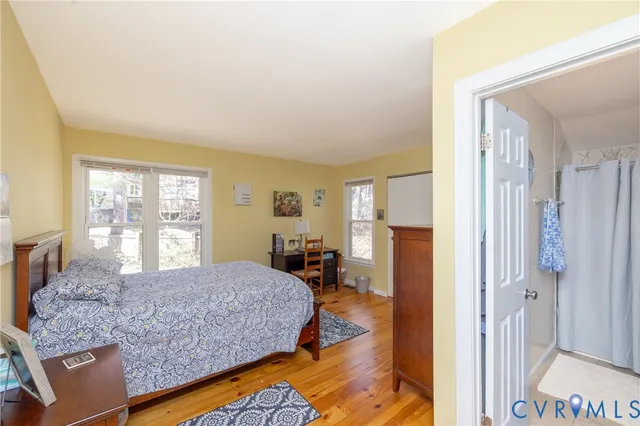 a living room with a bed furniture and a large window