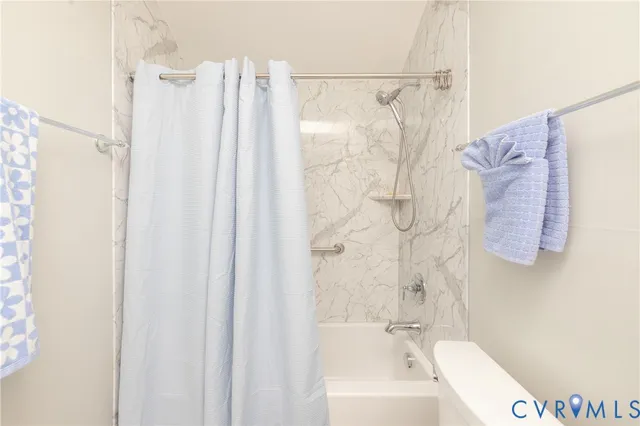a bathroom with a shower curtain and a bathtub