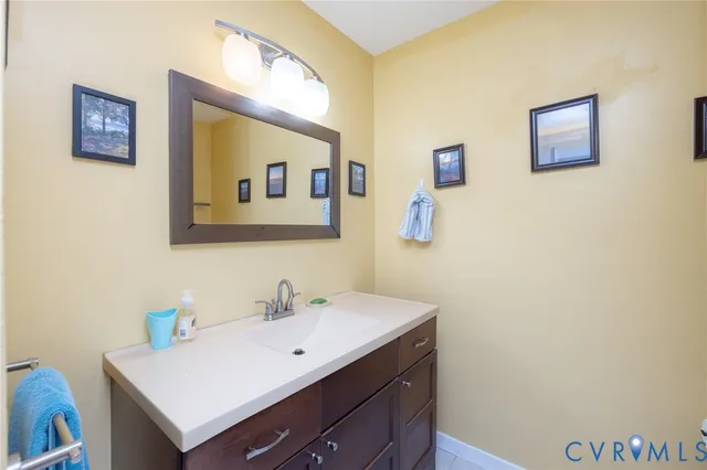 a bathroom with a sink mirror and vanity