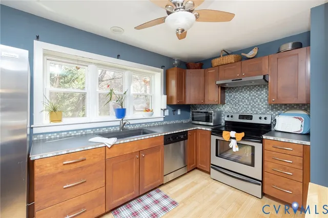 a kitchen with stainless steel appliances granite countertop a stove and a sink