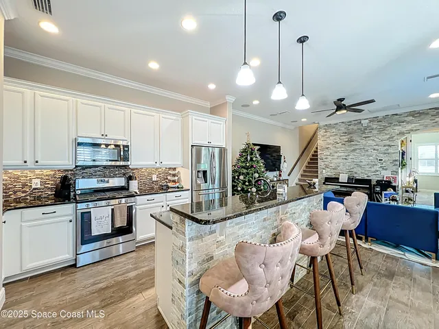 a view of a dining room with furniture and windows